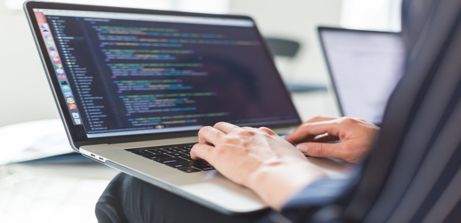 A placeholder stock image of a man typing on a laptop